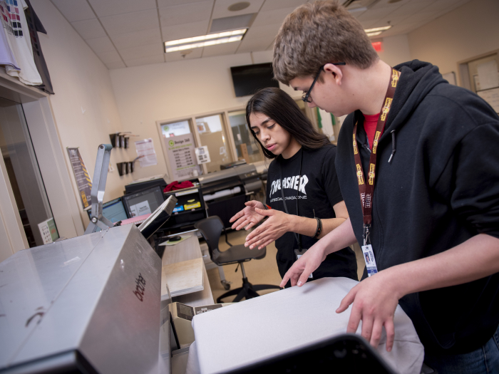 Students using screen printer