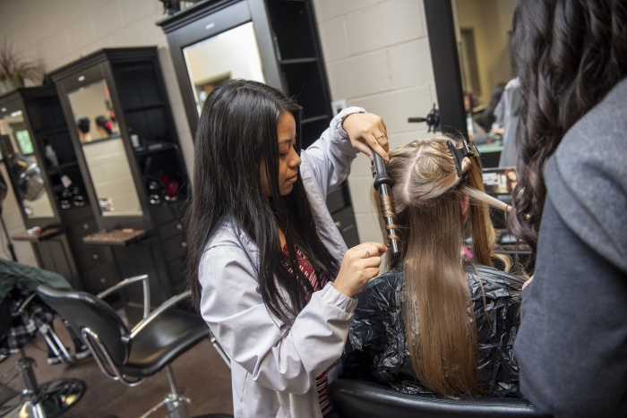 Students style hair.