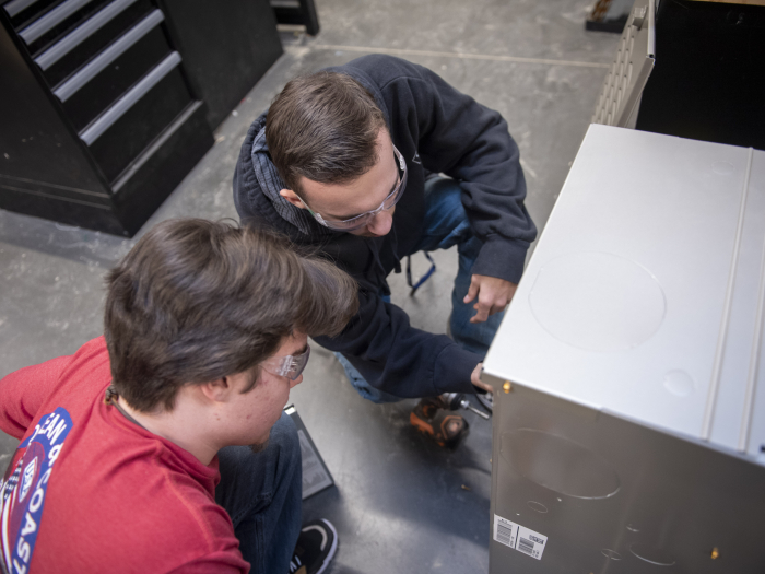 Students working on HVAC unit