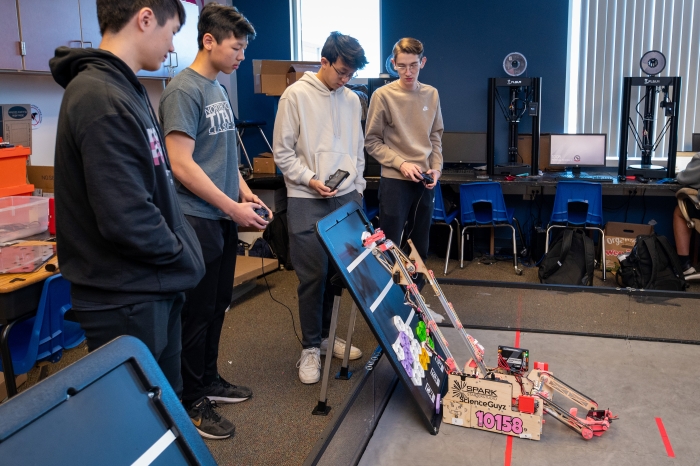 Students work with a simple machine.