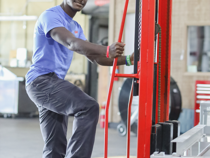 A student working in a warehouse.