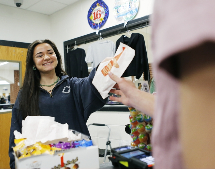 A student works at a school store.