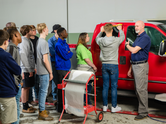 Student doing demonstration on car