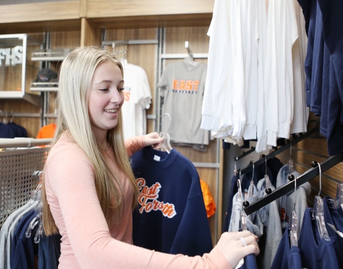 A student works at a school store.